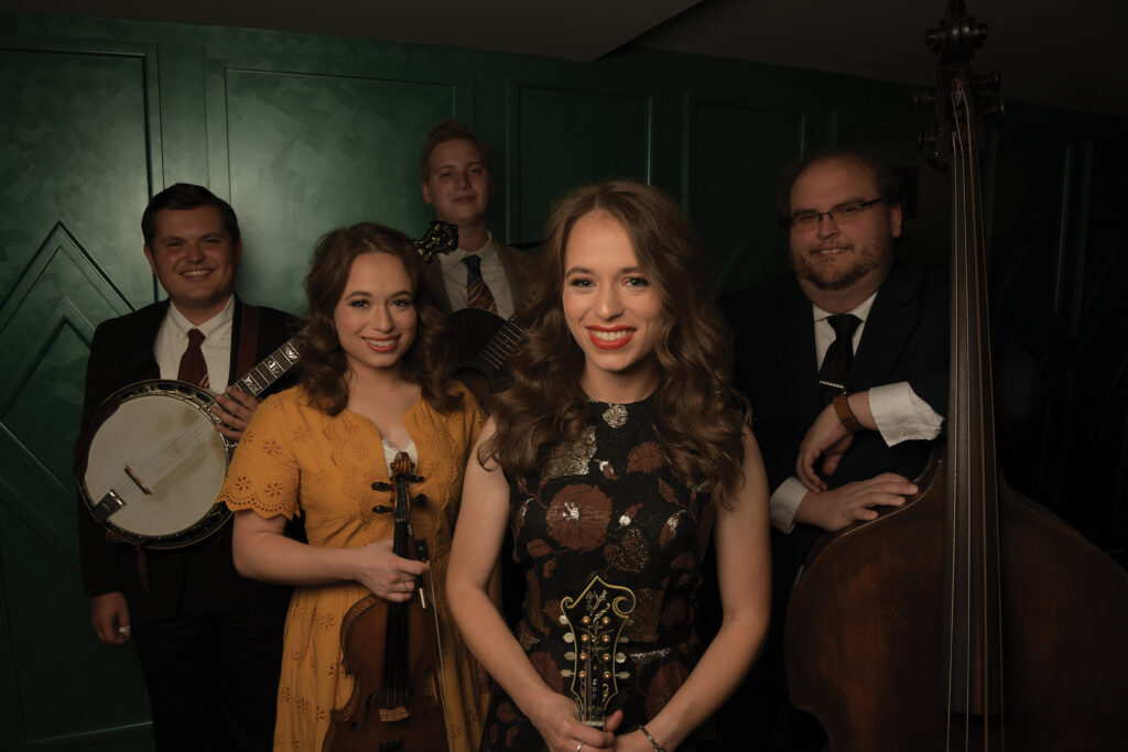 Trevor with the Price Sisters (left to right) Trevor Holder, Leanna Price, Conner Vlietstra, Lauren Price Napier, Bobby Osborne II. Photo by Allen Clark