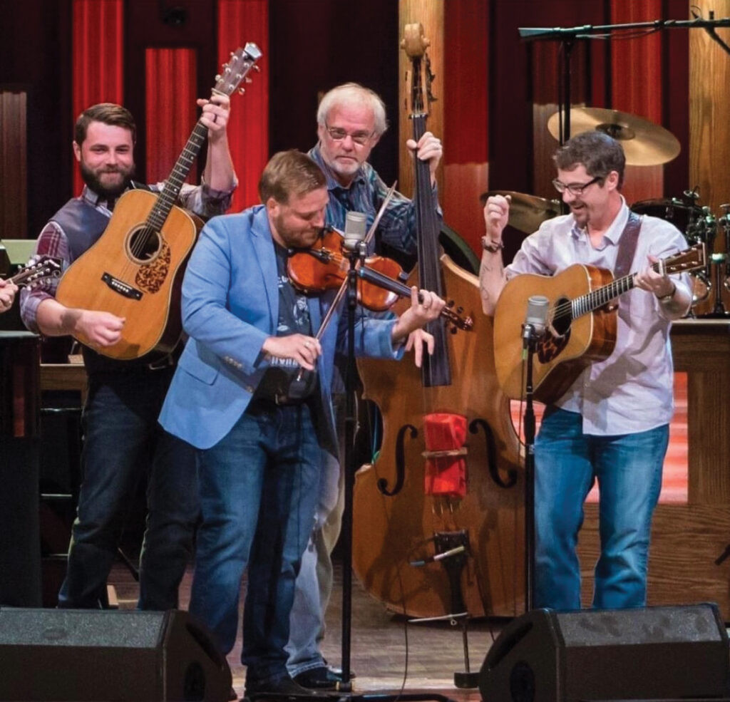 Left to Right: John Bryan, Adam Haynes, Terry Smith and Chris Davis performing at the Grand Ole Opry. // Photo by LuAnn Smith