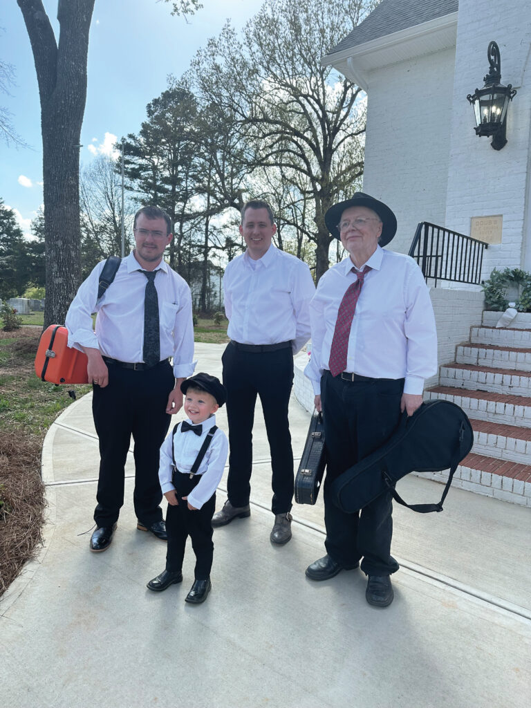 Jan Johannson after a performance at a wedding with Nathan Aldridge and Seth Rinehart.  The unidentified boy was a wedding guest.  Photo Courtesy of Jan Johannson.