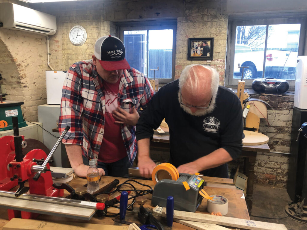 Instructor Josh Reese assisting Danny Slye with fingerboard.
Photo by Catherine Schrenker