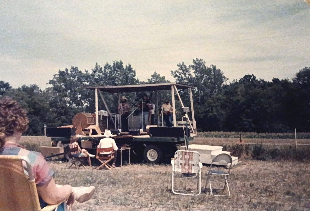  The 1982 Backbone Bluegrass Festival stage in a hayfield.  Photo Courtesy of Kaitlyn Briggs.