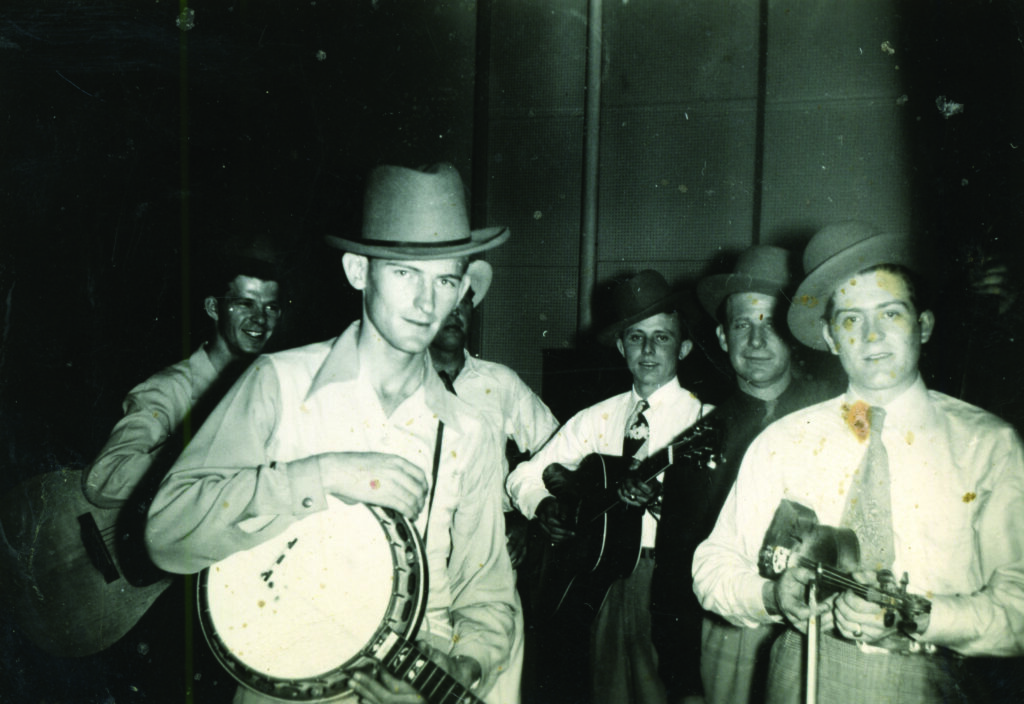 Bill Monroe and his Blue Grass Boys, Nashville, TN, May 15, 1948. (left to right) Jim Eanes, Don Reno, Bill Monroe (partially hidden), Jackie Phelps, Joel Price, Benny Martin.  Photo by Bernadine Davis, Reno Family/Jeremy Stephens Collection
