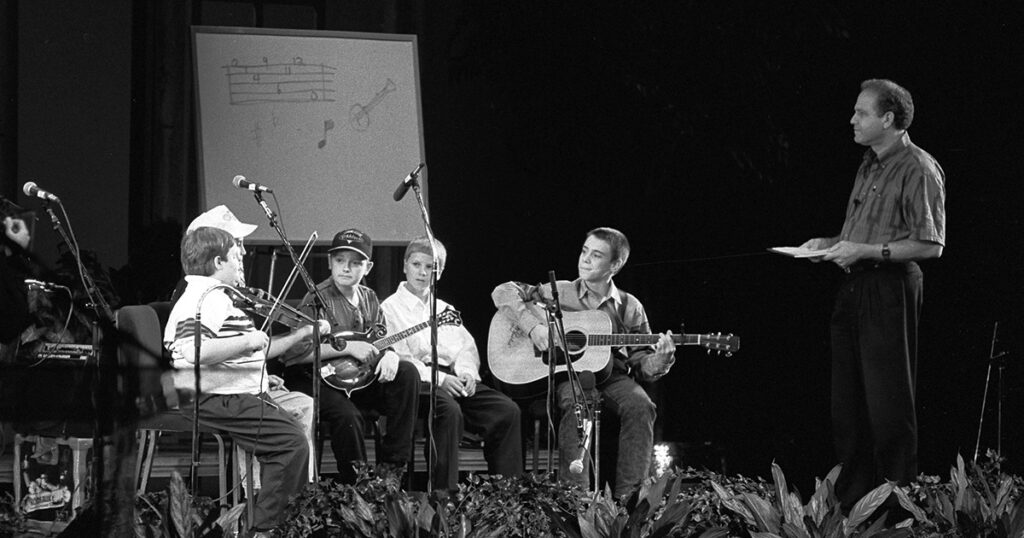 1993 IBMA Bluegrass Youth All-Stars (left to right) Michael Cleveland, Josh Williams (only cap visible), Chris Thile, Brady Stogdill, Cody Kilby, Pete Wernick. // Photo by Nobuharu Komoriya