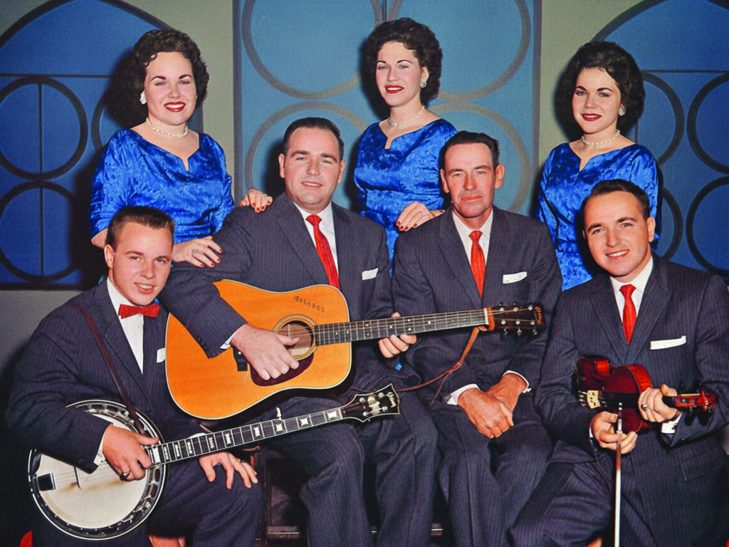Talmadge Lewis with the Lewis Family, ca. 1960. Front row, left to right: Little Roy, Wallace, Pop, and Talmadge. Back row, left to right: Polly, Miggie, and Janis
